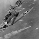 US Navy Douglas SBD Dauntless dive bombers from USS Hornet fly over the burning Japanese cruiser Mikuma during the Battle of Midway (US Navy)